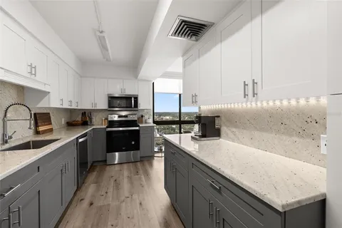 a kitchen with a stove a sink and a microwave
