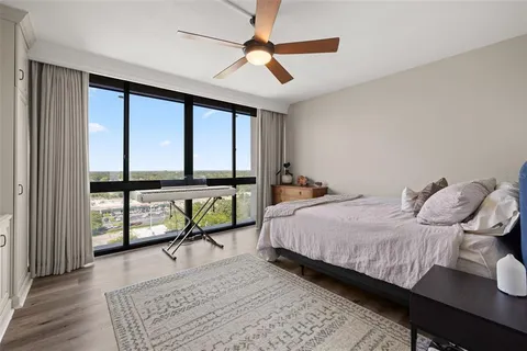 a bedroom with a large bed and a chandelier