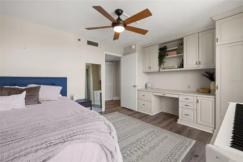 a bedroom with a bed and wooden floor
