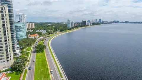 a city view with tall buildings and a yard