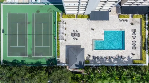 a swimming pool with outdoor seating and yard