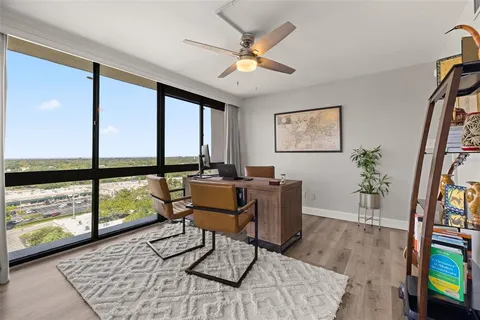 a workspace with furniture window and wooden floor
