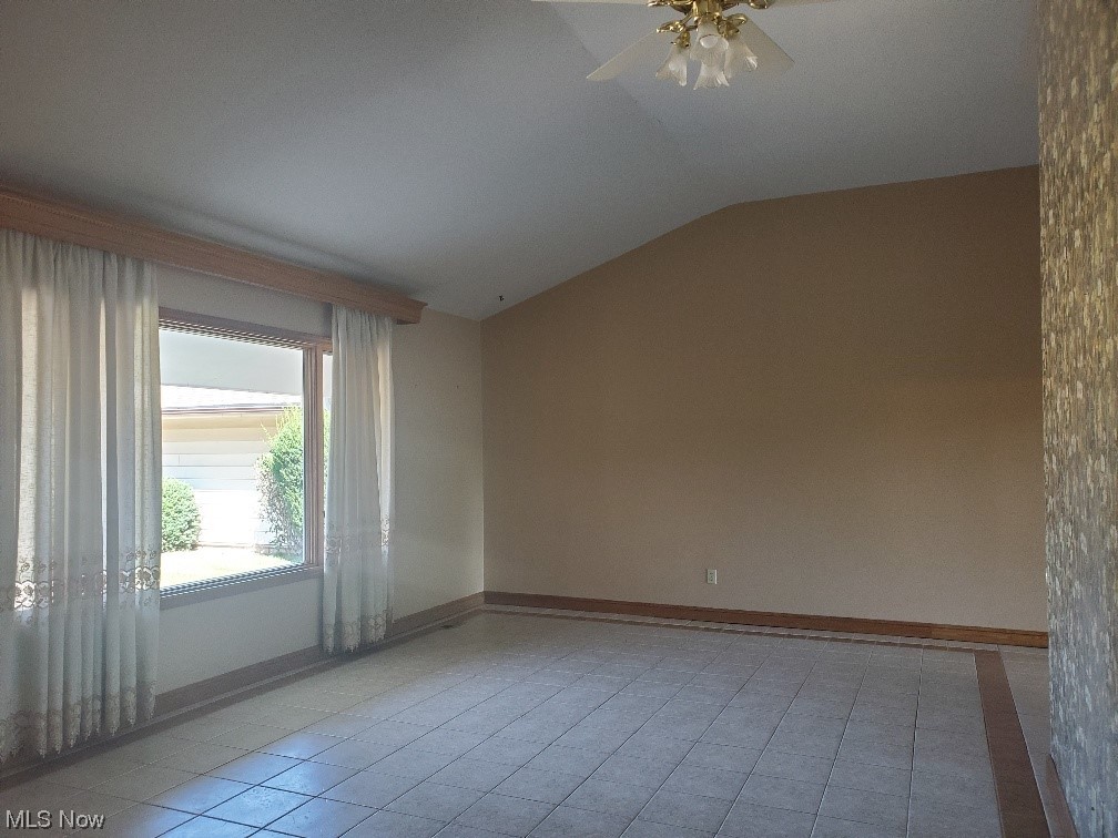 12221 Reno Drive Parma, OH 44130 - Photo 9 of 29 Tiled spare room with lofted ceiling and ceiling fan