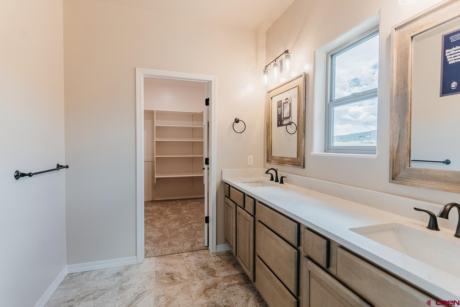 22280 6845 Road Montrose, CO 81403 - Photo 14 of 34 a bathroom with a sink double vanity and a tub