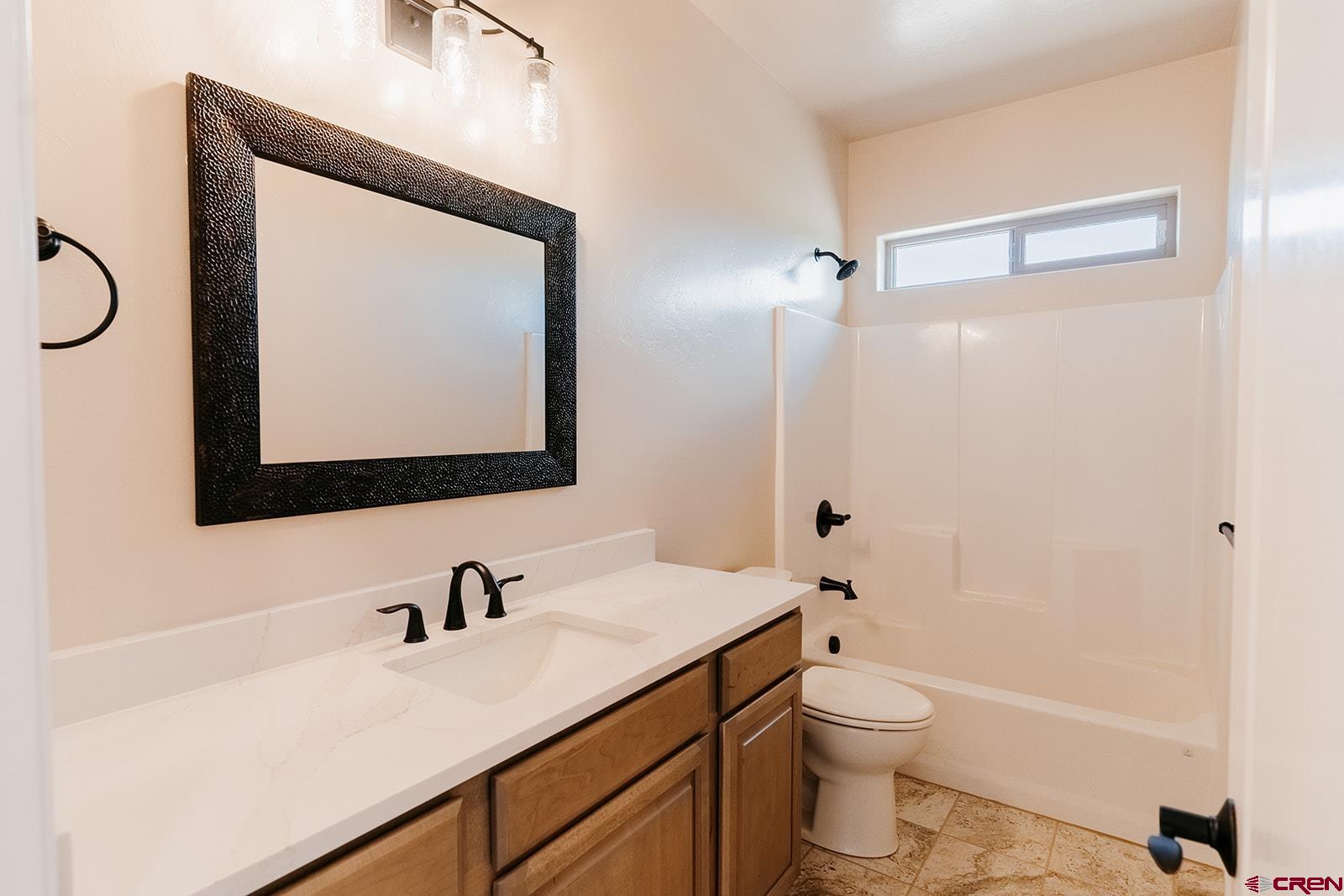 22280 6845 Road Montrose, CO 81403 - Photo 18 of 34 a bathroom with a toilet sink vanity granite and mirror