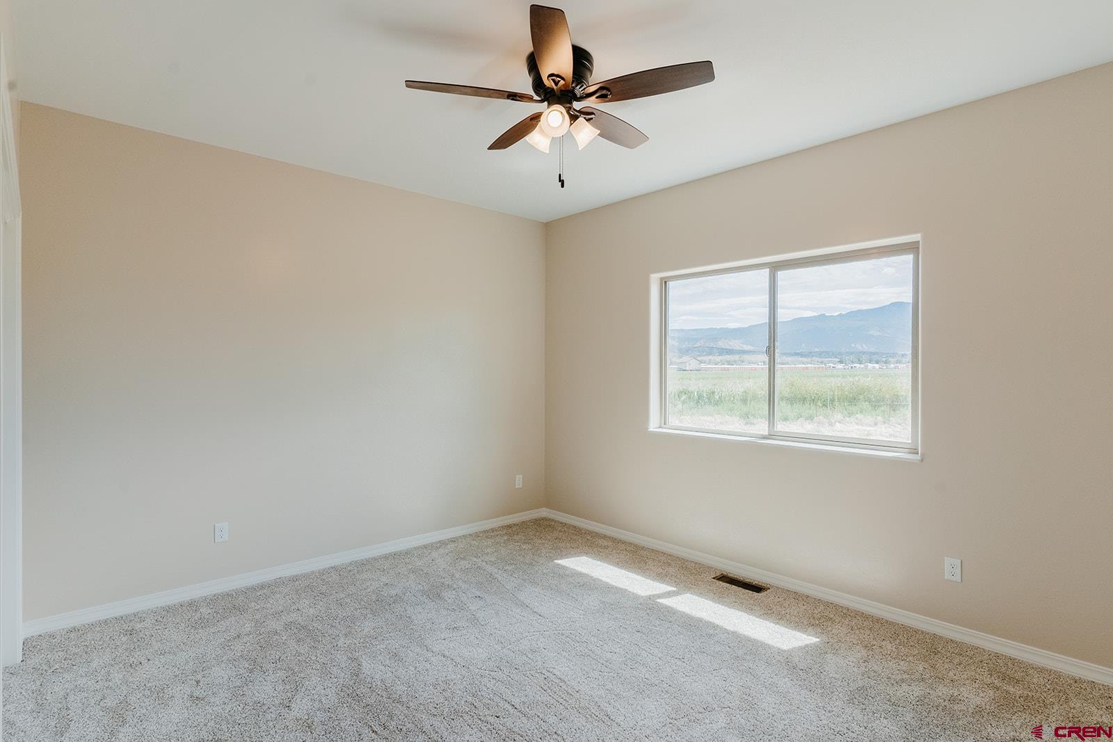 22280 6845 Road Montrose, CO 81403 - Photo 19 of 34 an empty room with a window and a ceiling fan