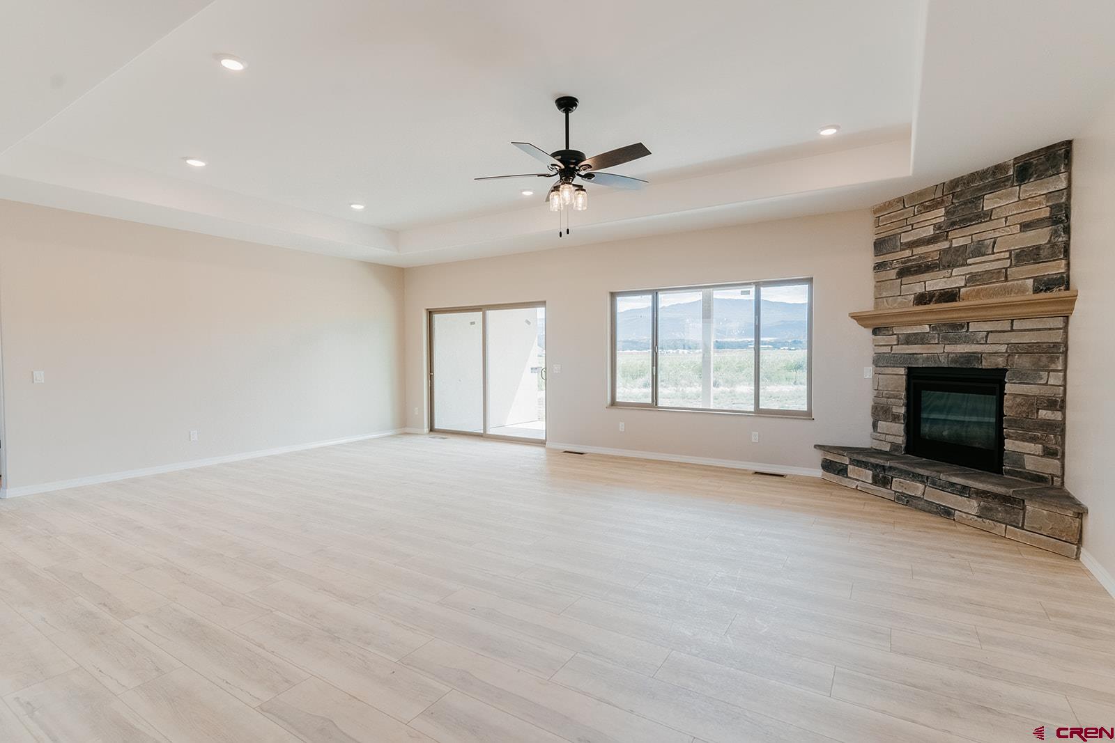 22280 6845 Road Montrose, CO 81403 - Photo 3 of 34 an empty room with windows and fireplace