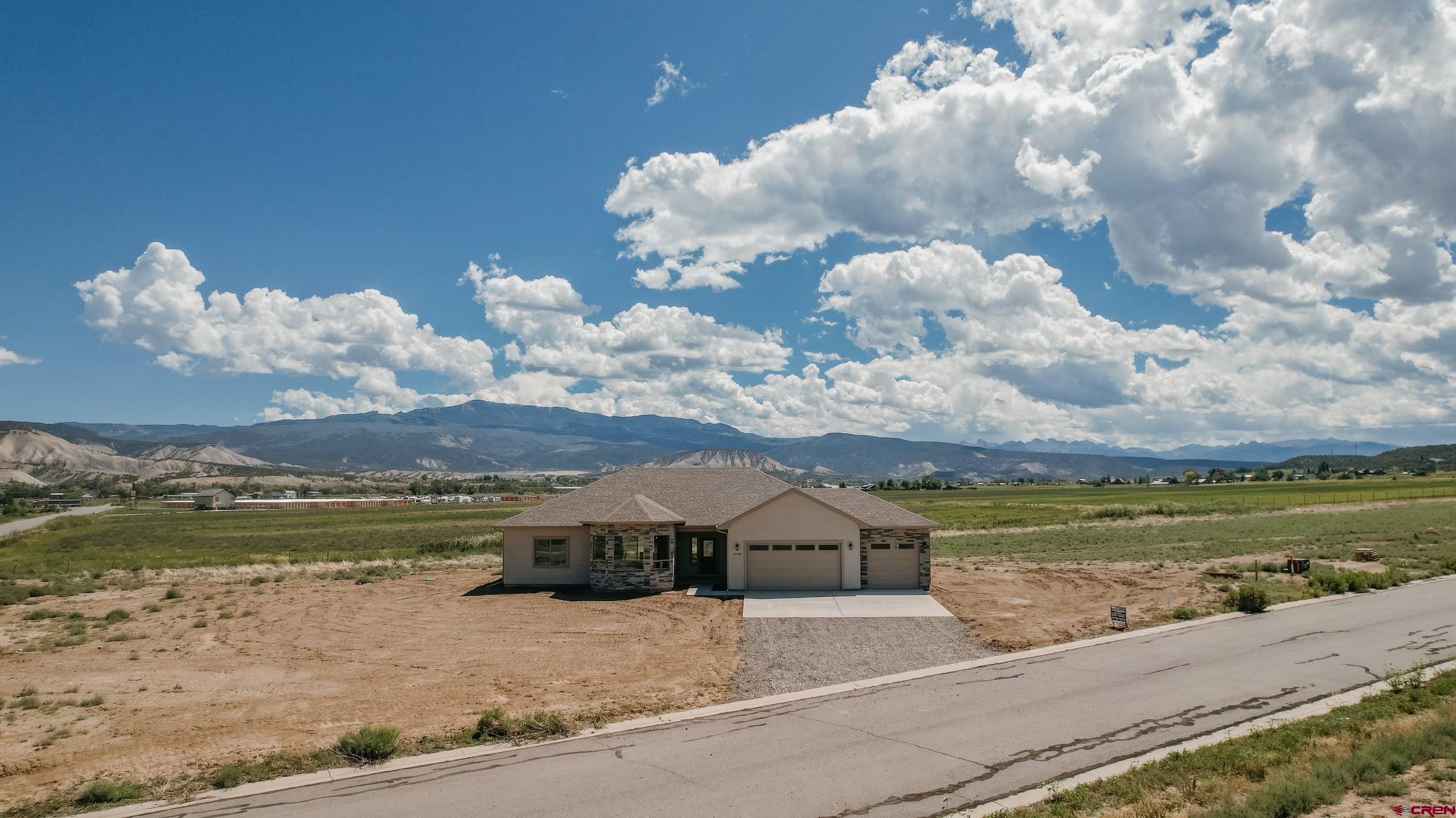 22280 6845 Road Montrose, CO 81403 - Photo 31 of 34 a view of a house with a yard