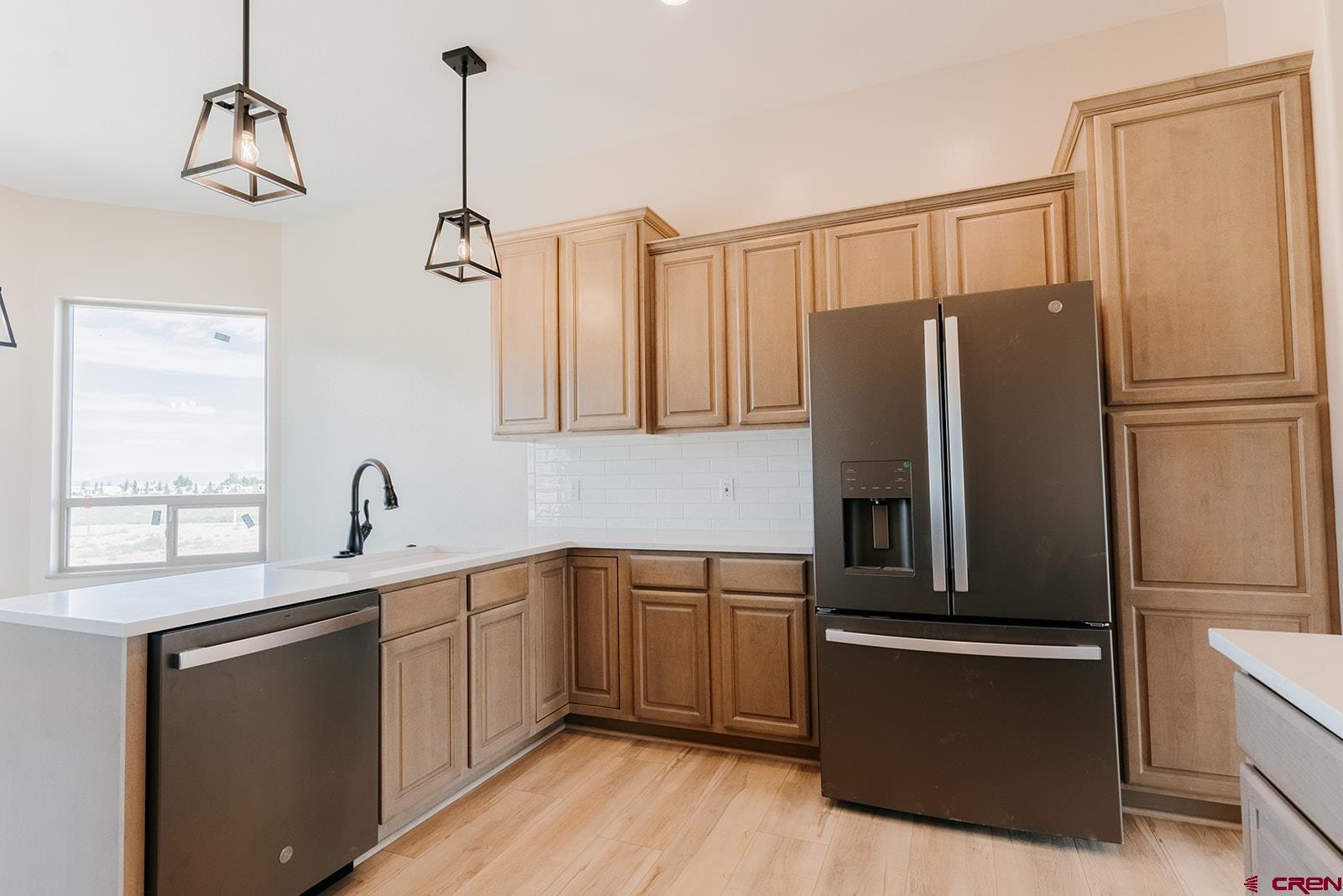 22280 6845 Road Montrose, CO 81403 - Photo 5 of 34 a kitchen with a refrigerator sink and cabinets