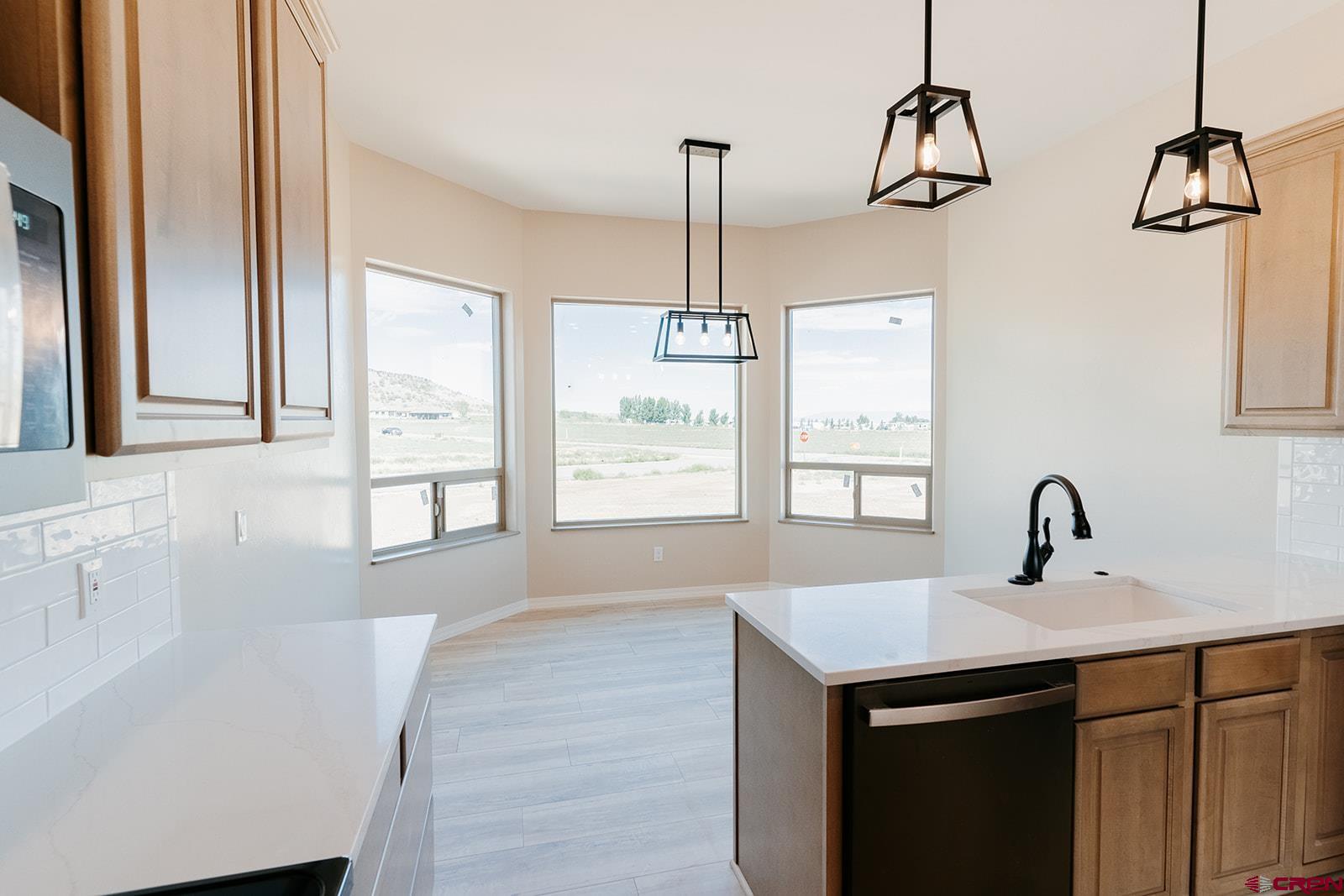 22280 6845 Road Montrose, CO 81403 - Photo 7 of 34 a kitchen with a sink cabinets and window