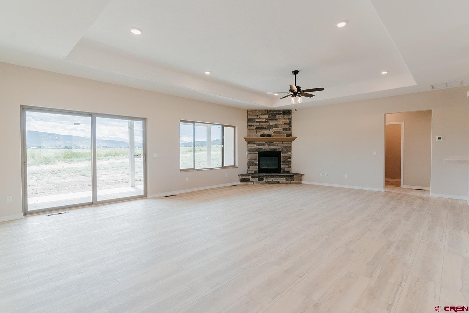 22280 6845 Road Montrose, CO 81403 - Photo 8 of 34 an empty room with windows and ceiling fan