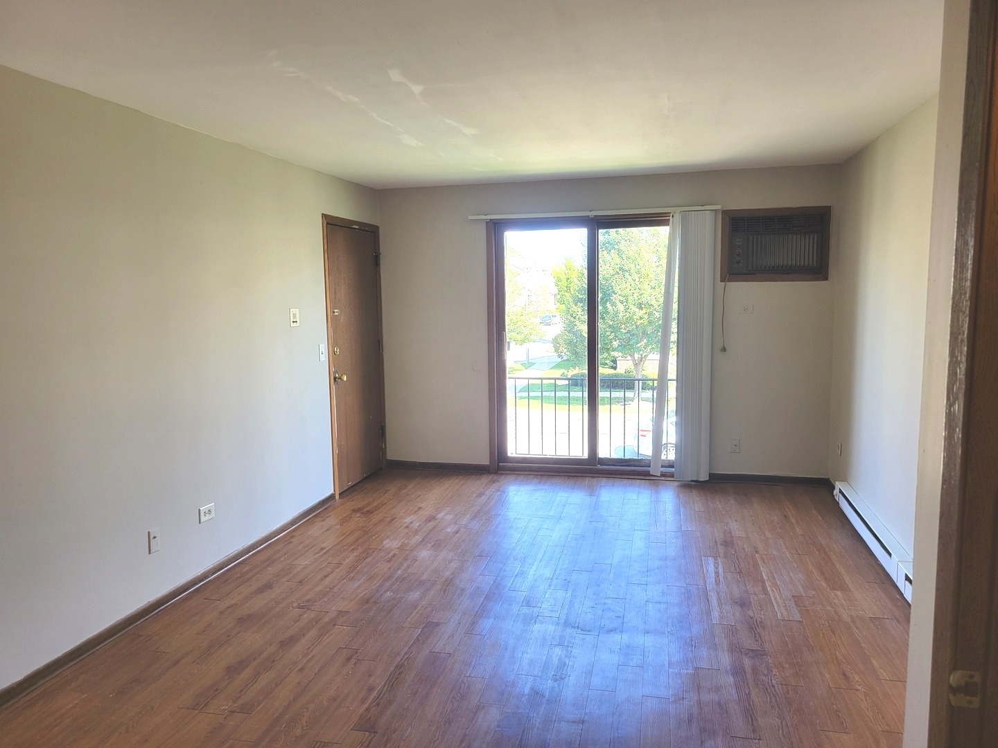 1257 Harding Avenue, Unit A2 Des Plaines, IL 60016 - Photo 2 of 9 a view of a big room with wooden floor and windows
