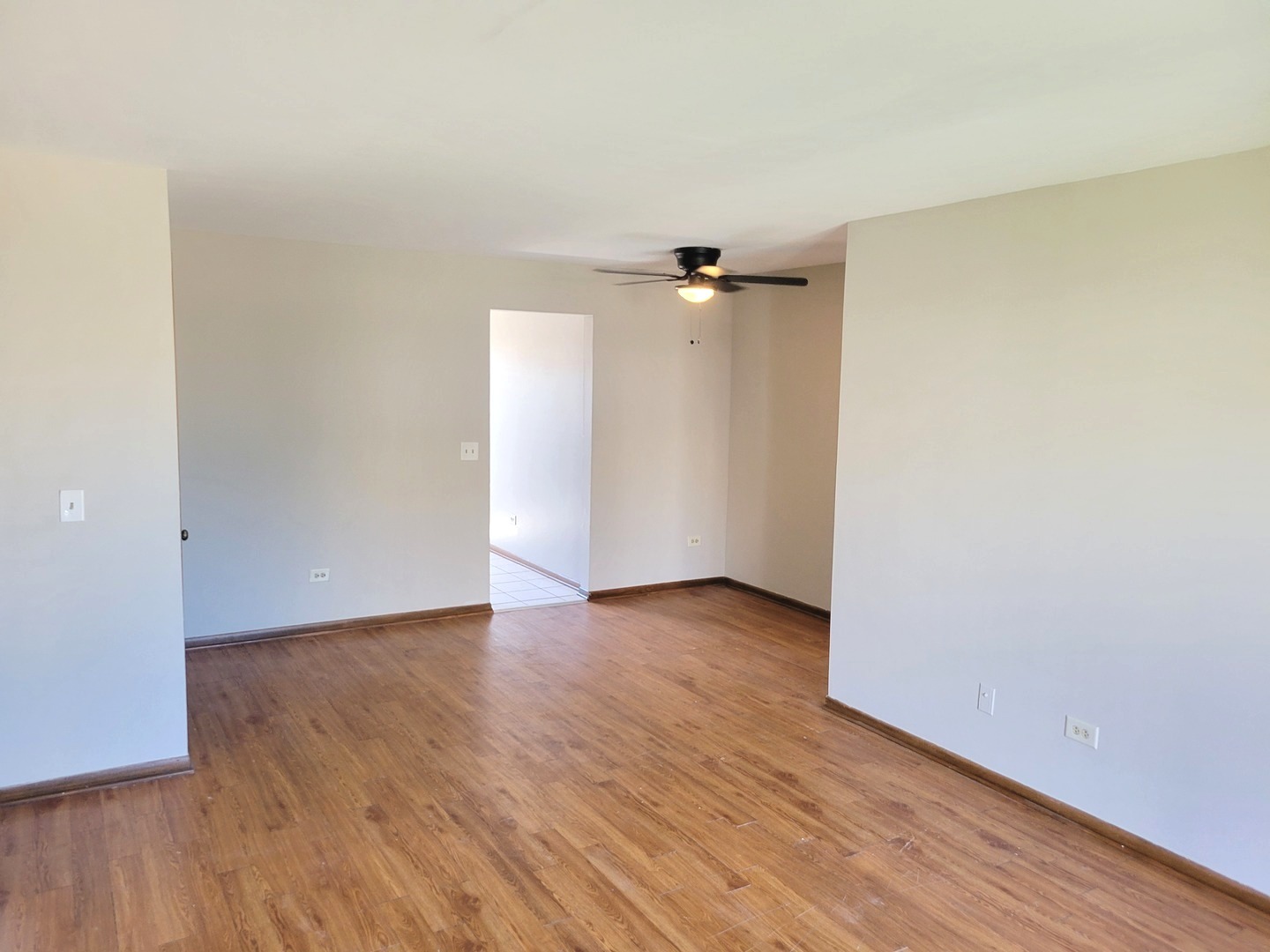 1257 Harding Avenue, Unit A2 Des Plaines, IL 60016 - Photo 3 of 9 an empty room with wooden floor