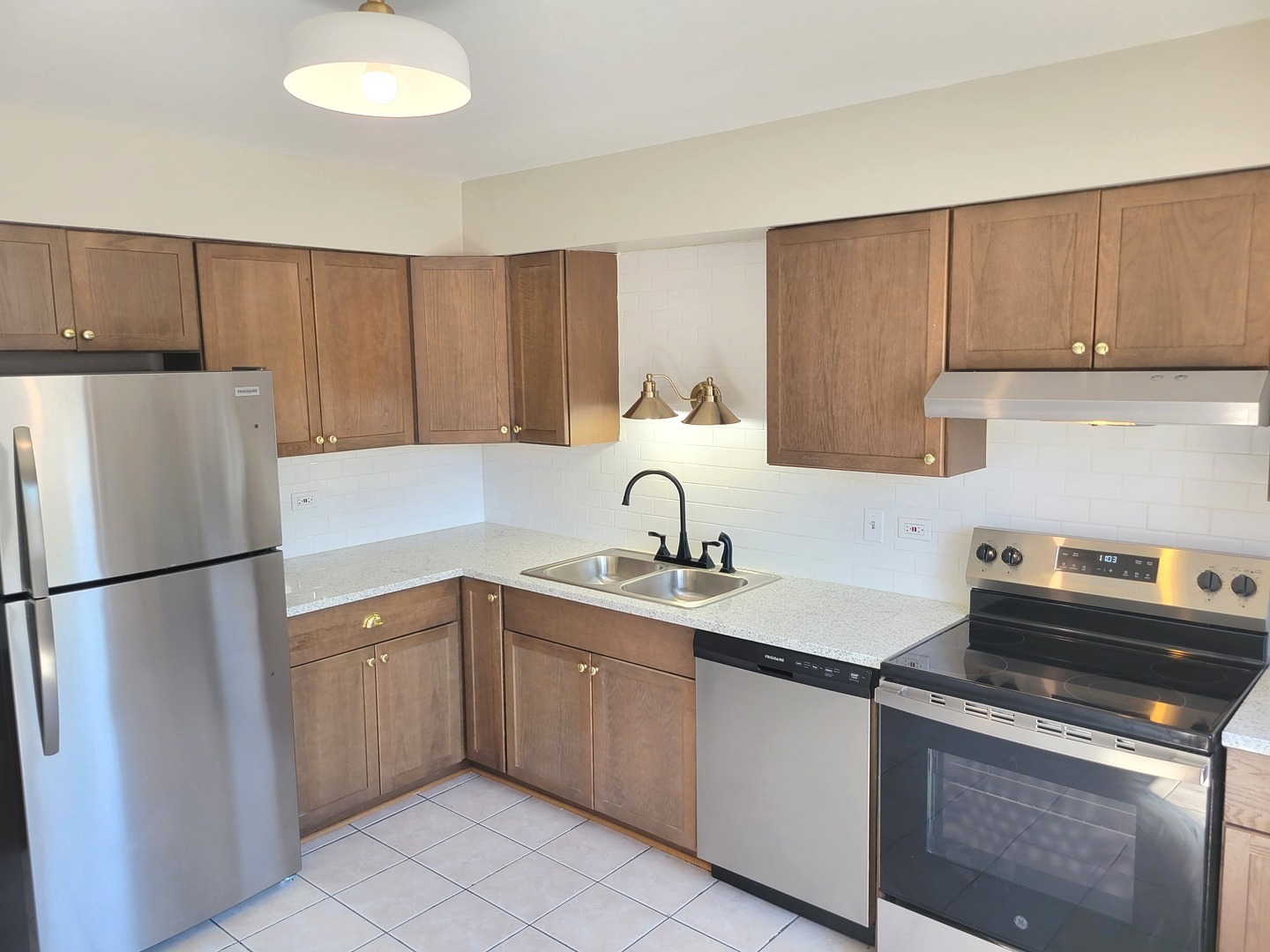 1257 Harding Avenue, Unit A2 Des Plaines, IL 60016 - Photo 4 of 9 a kitchen with a sink a refrigerator and cabinets