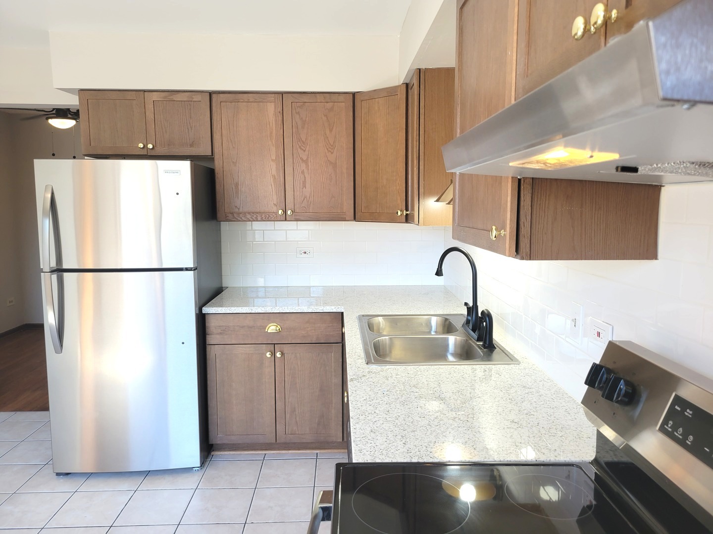 1257 Harding Avenue, Unit A2 Des Plaines, IL 60016 - Photo 5 of 9 a kitchen with a refrigerator and a sink