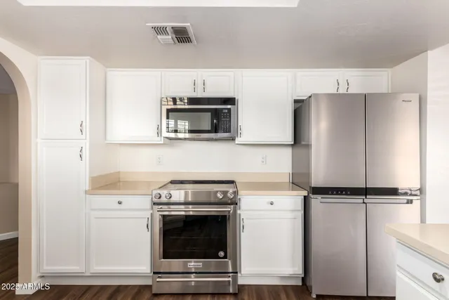 a kitchen with a refrigerator stove and microwave