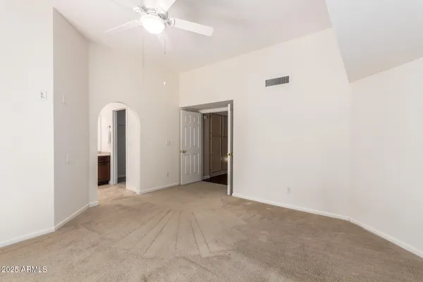 a view of an empty room with a ceiling fan