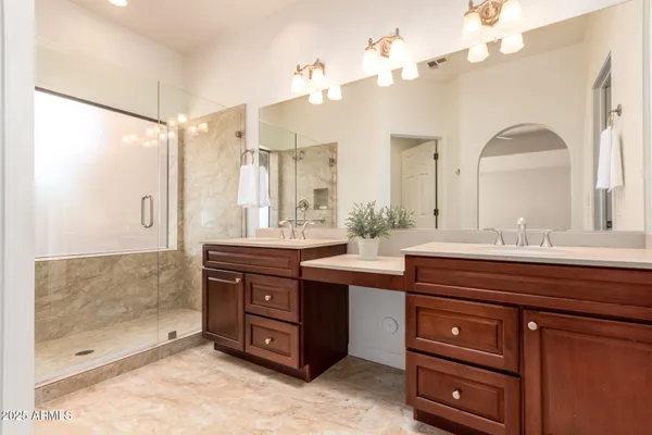 a bathroom with a double vanity sink mirror and double
