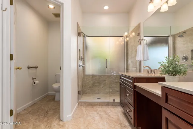 a bathroom with a shower sink and mirror