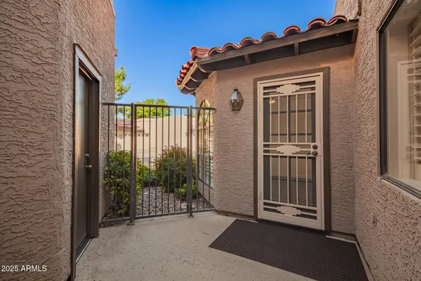 a view of a house with a small yard and floor to ceiling window
