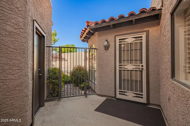 a view of a house with a small yard and floor to ceiling window