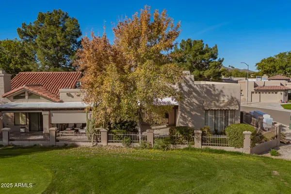a front view of a house with a garden