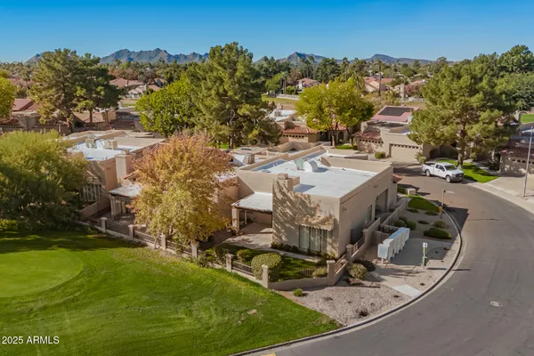 an aerial view of a house with a yard basket ball court and outdoor seating