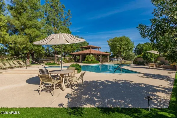 a patio with a yard table and chairs