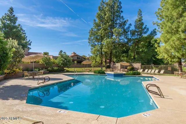 a view of a swimming pool with lounge chairs