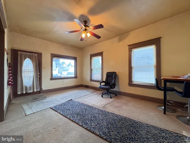 a view of a workspace with furniture and a window