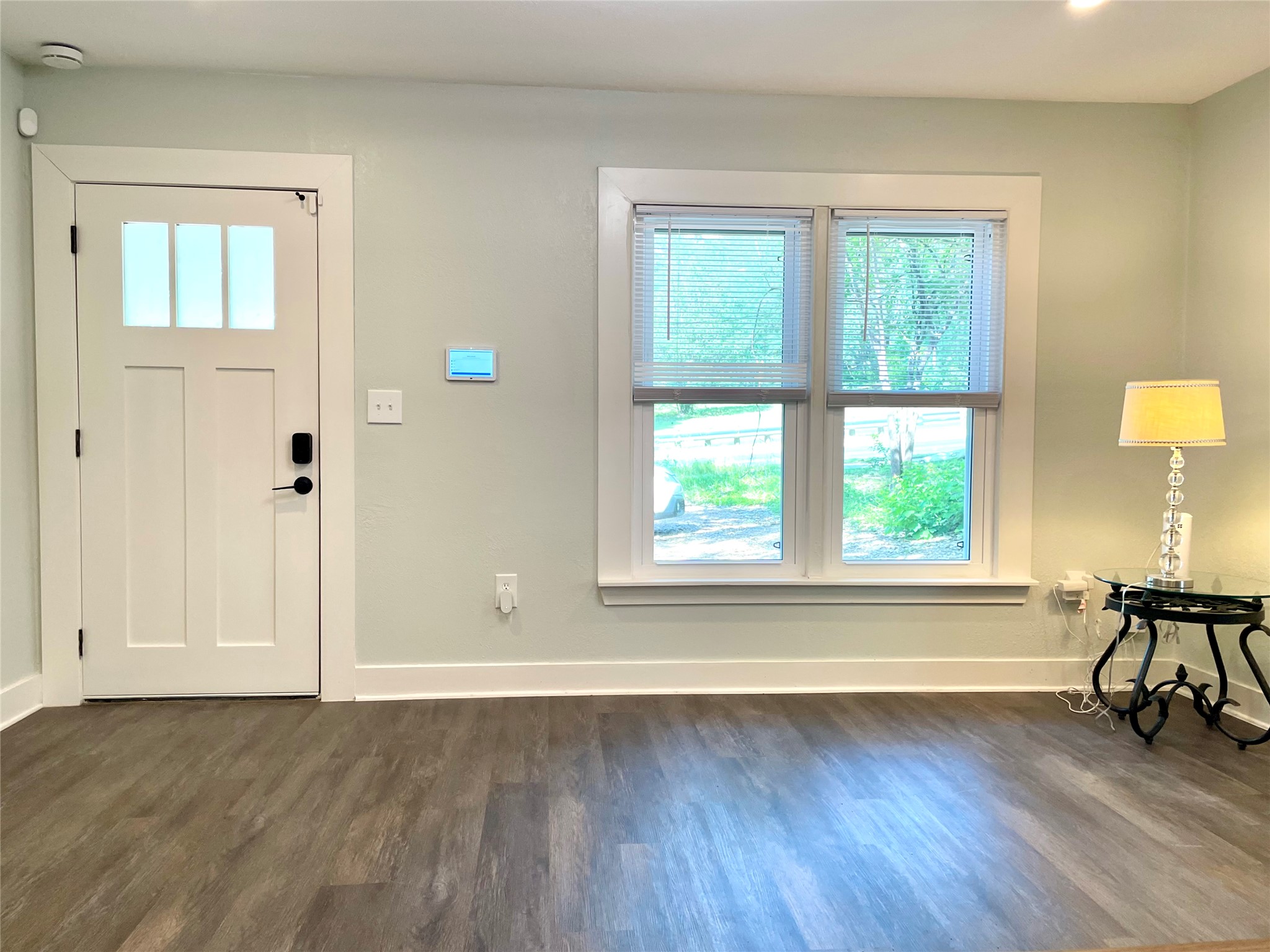807 East Riverside Drive, Unit B Austin, TX 78704 - Photo 4 of 28 Enter a well-lit living area, featuring rich wood-look flooring and a modern entryway.