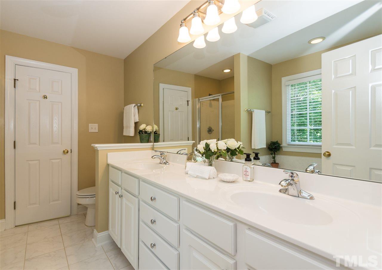 11704 John Allen Road Raleigh, NC 27614 - Photo 13 of 25 a bathroom with a double vanity sink mirror and next to a window