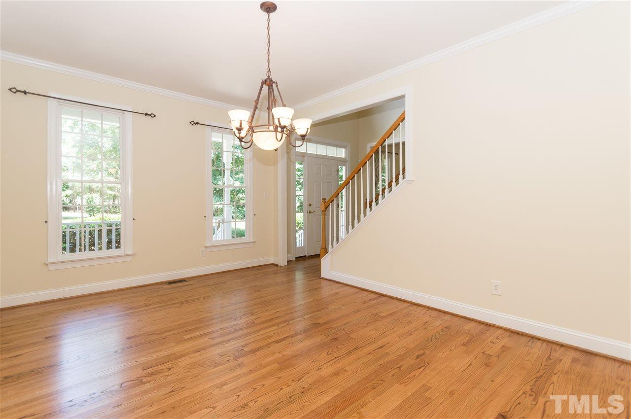 11704 John Allen Road Raleigh, NC 27614 - Photo 4 of 25 a view of an empty room with wooden floor and a window