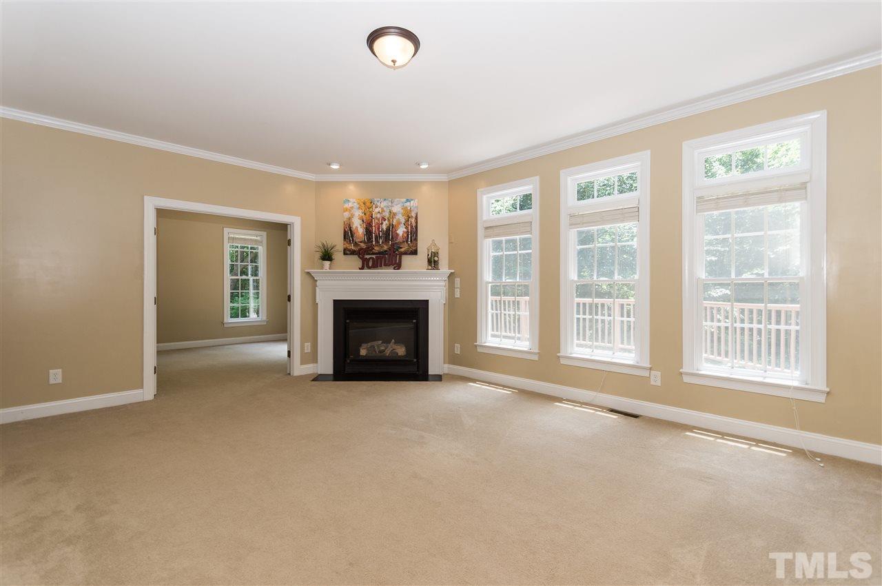 11704 John Allen Road Raleigh, NC 27614 - Photo 5 of 25 a view of an empty room with a fireplace and a window