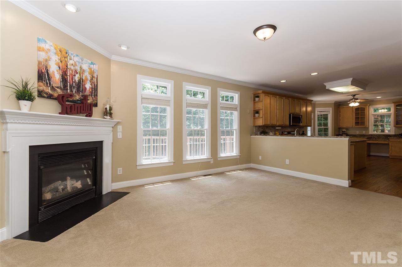 11704 John Allen Road Raleigh, NC 27614 - Photo 6 of 25 a view of a livingroom with a fireplace and large windows