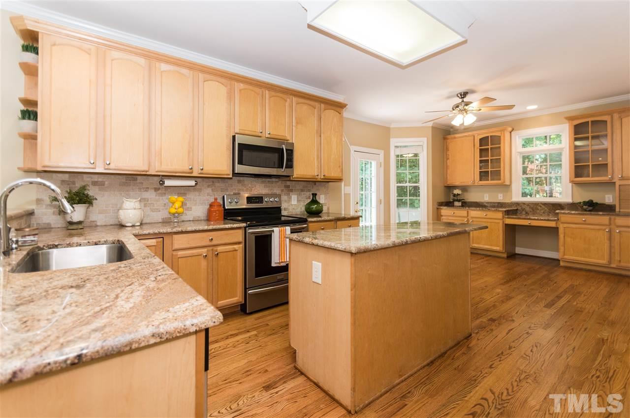 11704 John Allen Road Raleigh, NC 27614 - Photo 8 of 25 a kitchen with stainless steel appliances granite countertop a stove top oven a sink dishwasher a microwave oven and a dining table with wooden cabinet