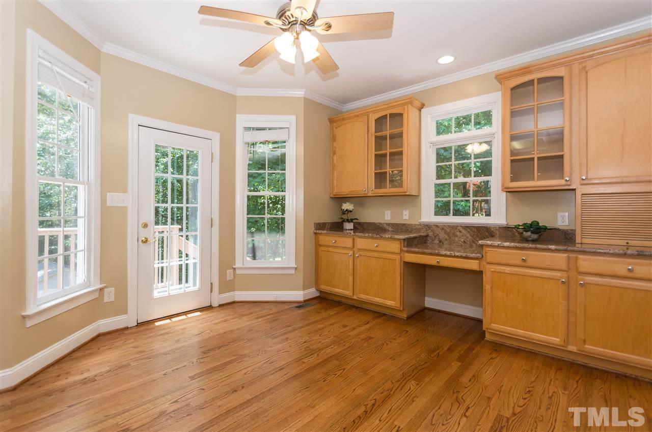 11704 John Allen Road Raleigh, NC 27614 - Photo 10 of 25 a large kitchen with granite countertop a stove a sink a window and cabinets