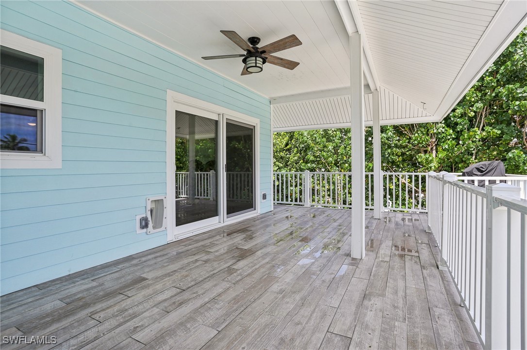 8335 Main Street Bokeelia, FL 33922 - Photo 13 of 47 an empty room with wooden floor and balcony