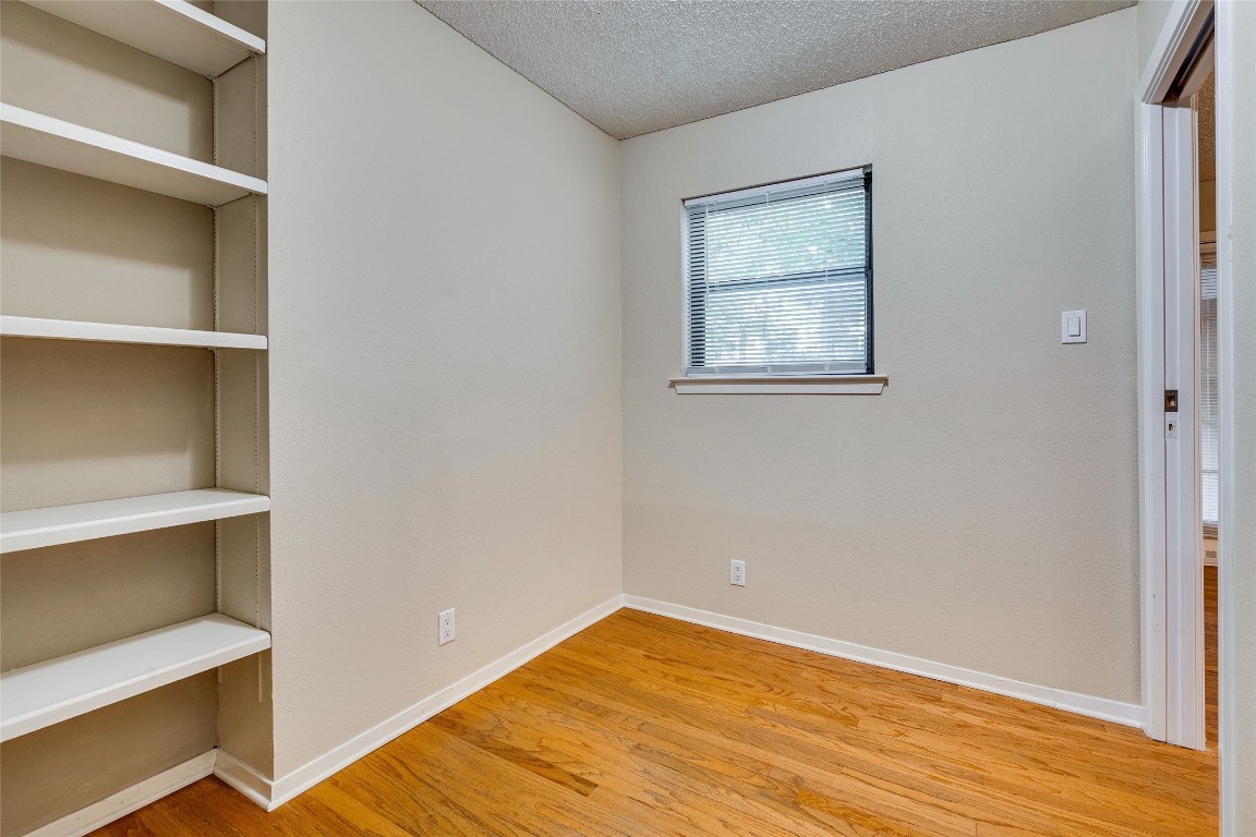 2110 Rio Grande Street, Unit 208 Austin, TX 78705 - Photo 14 of 31 a view of room with wooden floor and window