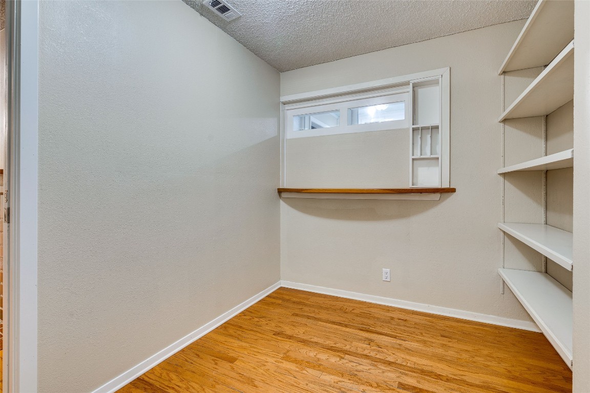 2110 Rio Grande Street, Unit 208 Austin, TX 78705 - Photo 16 of 31 a view of empty room with wooden floor and cabinet