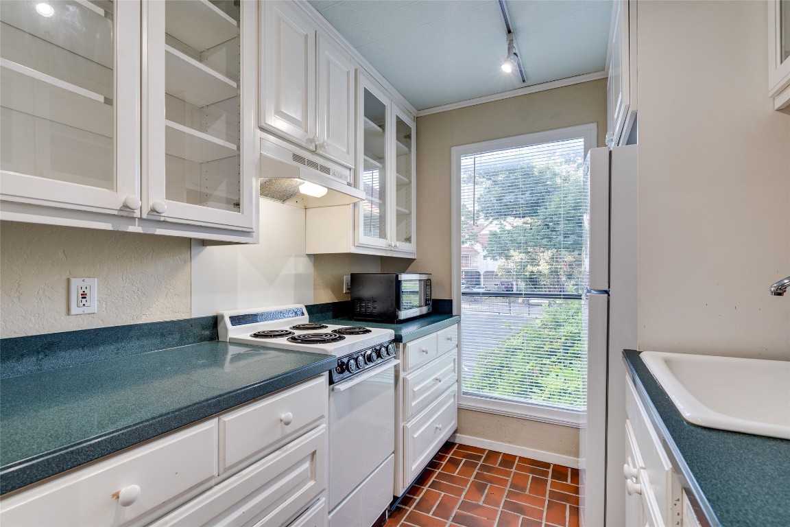 2110 Rio Grande Street, Unit 208 Austin, TX 78705 - Photo 19 of 31 a kitchen with stainless steel appliances cabinets and a window