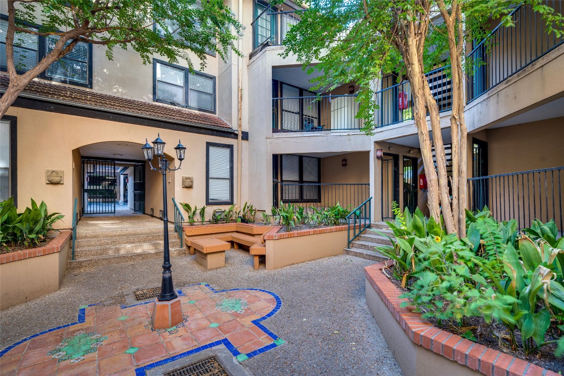 2110 Rio Grande Street, Unit 208 Austin, TX 78705 - Photo 2 of 31 a view of a house with potted plants and a large tree