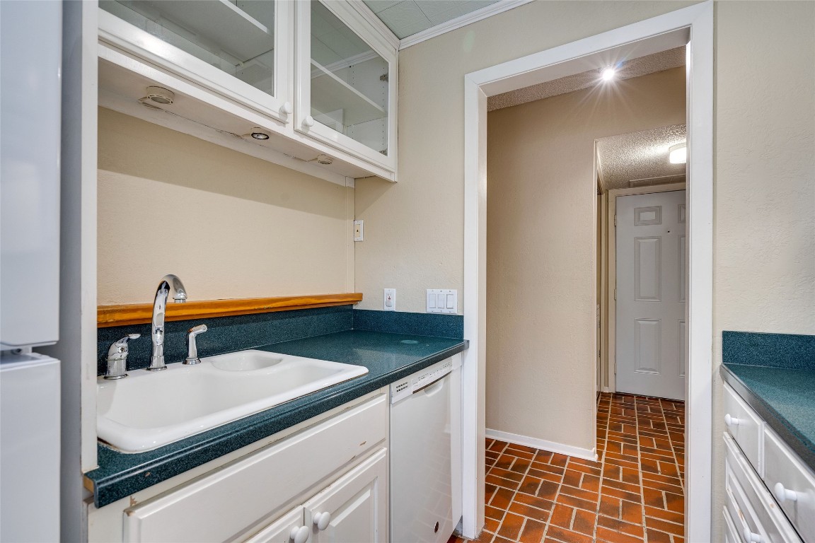 2110 Rio Grande Street, Unit 208 Austin, TX 78705 - Photo 21 of 31 a kitchen with a sink and a refrigerator