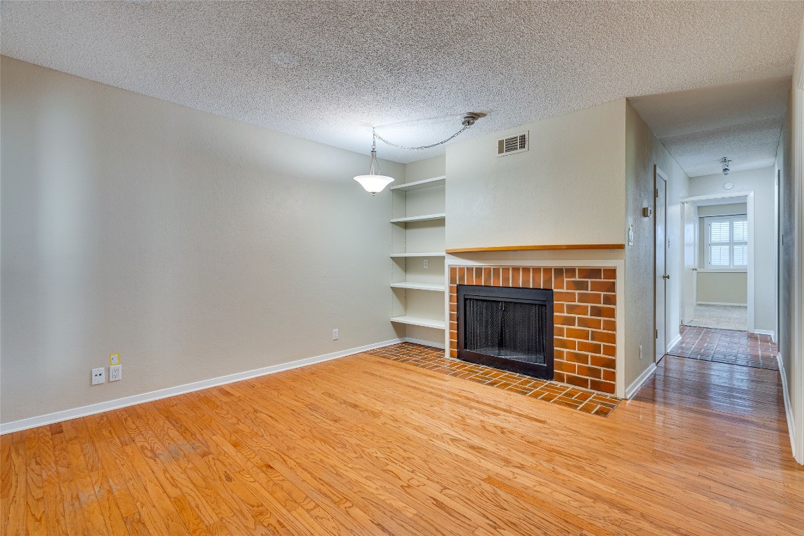 2110 Rio Grande Street, Unit 208 Austin, TX 78705 - Photo 8 of 31 wooden floor fireplace and windows in an empty room