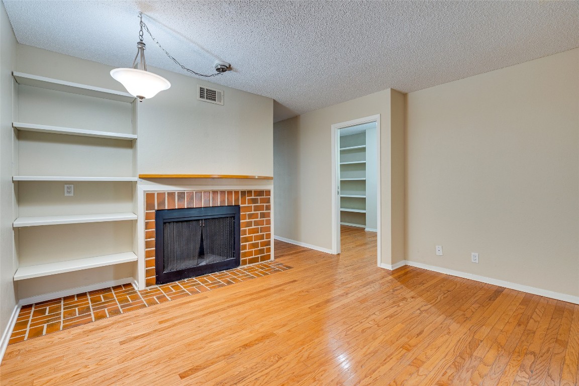 2110 Rio Grande Street, Unit 208 Austin, TX 78705 - Photo 9 of 31 a view of an empty room with a fireplace and a window