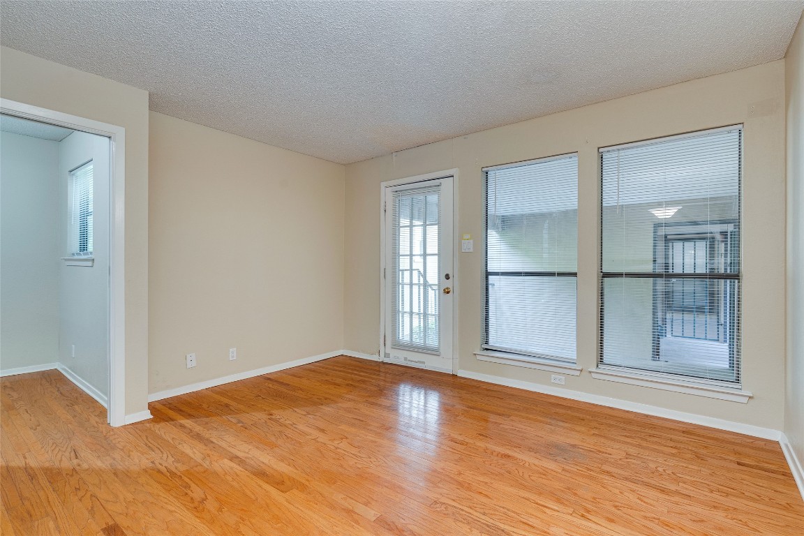 2110 Rio Grande Street, Unit 208 Austin, TX 78705 - Photo 10 of 31 a view of empty room with wooden floor and fan