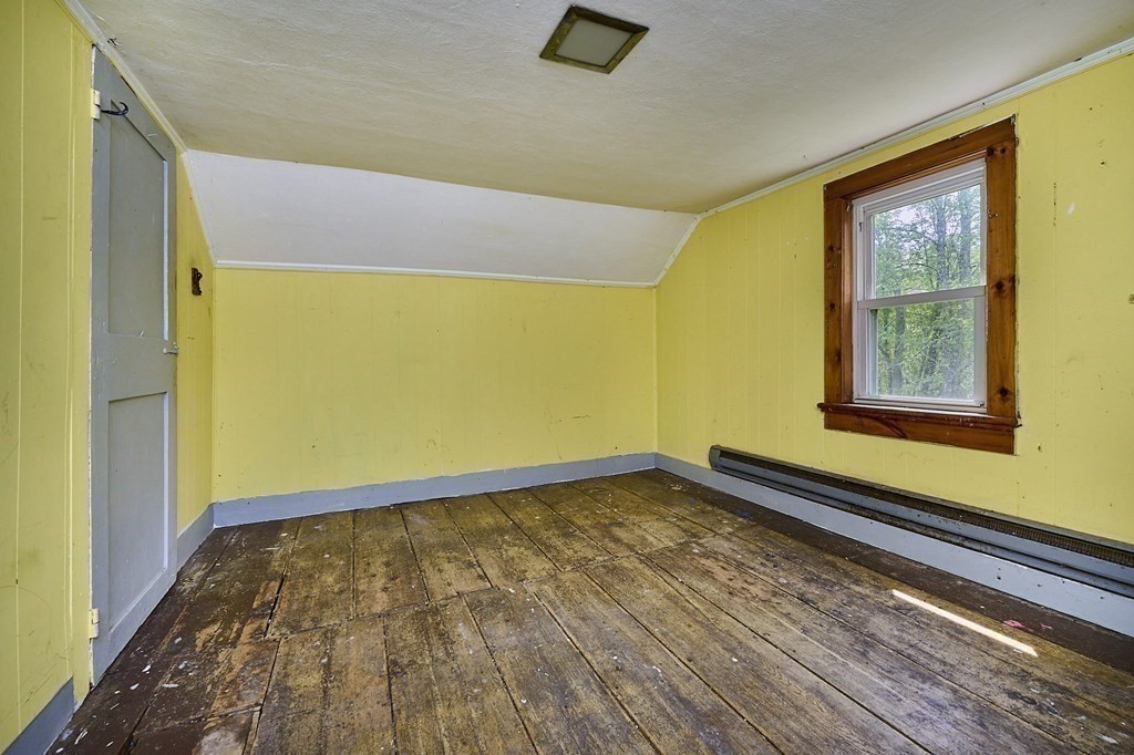 6 Mougin Road Cummington, MA 01026 - Photo 14 of 26 a view of an empty room with wooden floor and a window