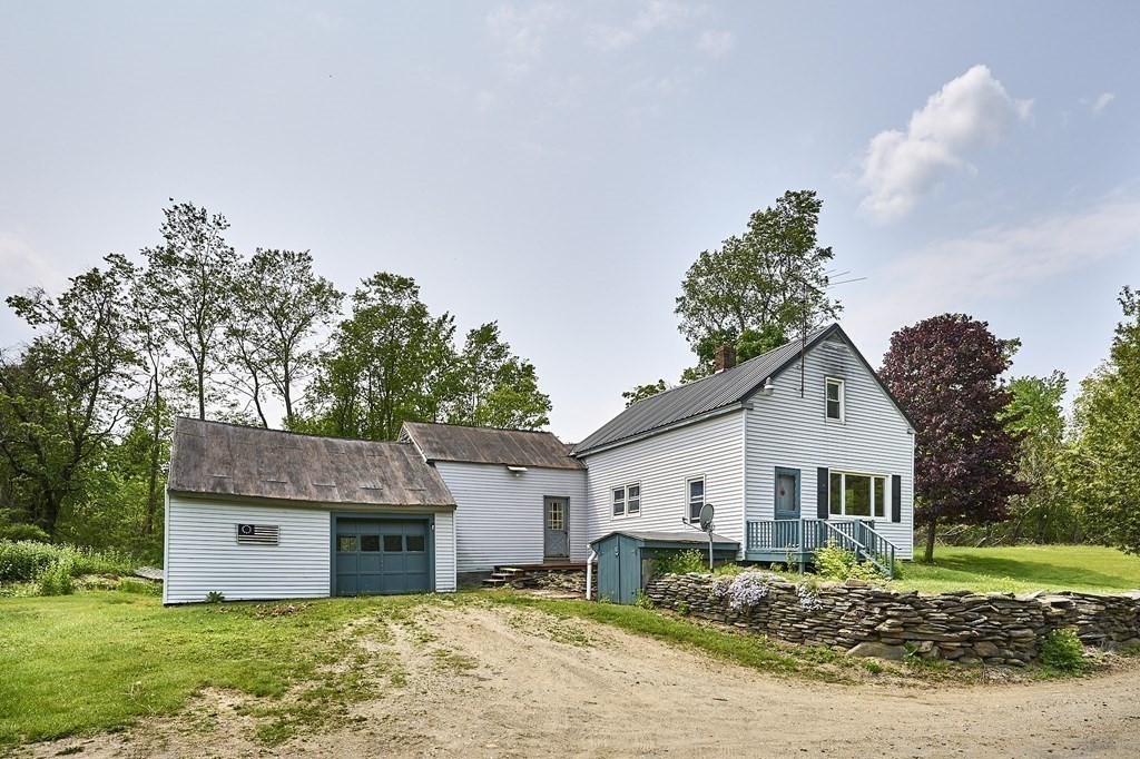6 Mougin Road Cummington, MA 01026 - Photo 5 of 26 a front view of a house with a yard and garage