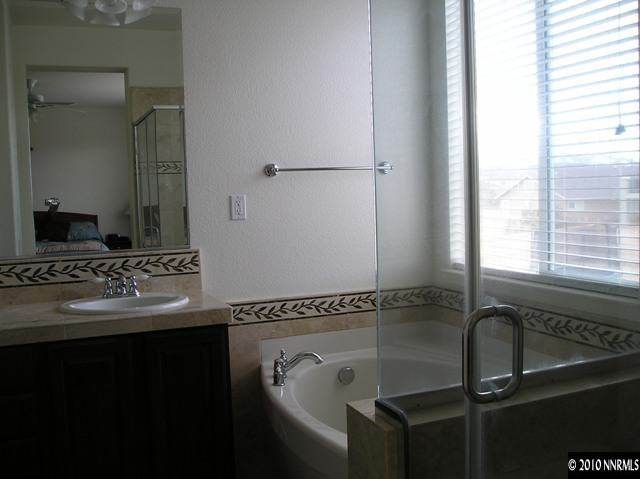 2570 Country Falls Lane Reno, NV 89521 - Photo 7 of 9 a bathroom with a granite countertop sink and a mirror