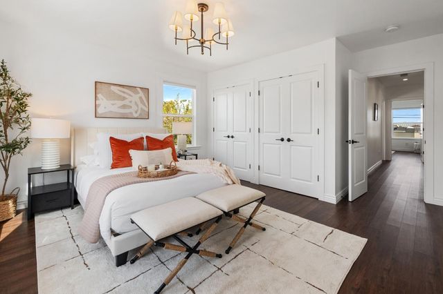 a bedroom with a bed and a chandelier